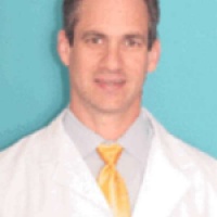 Dr. Travis  Holcombe MD